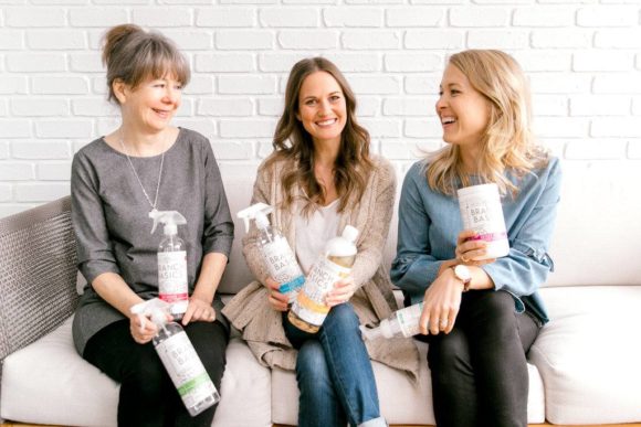 The branch basics team on a couch holding their products